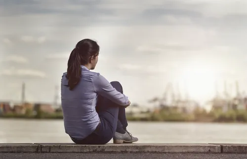 young woman gazing across a river