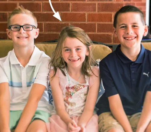 girl sitting with two brothers