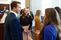 A group of single adults mingle after a church meeting