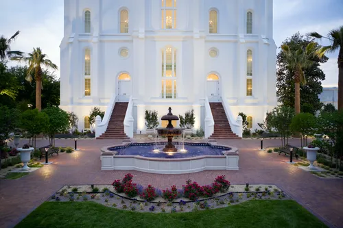 Exterior image of the St. George Utah Temple. The image features architectural details of the temple; specifically of the fountain outside the temple doors. 