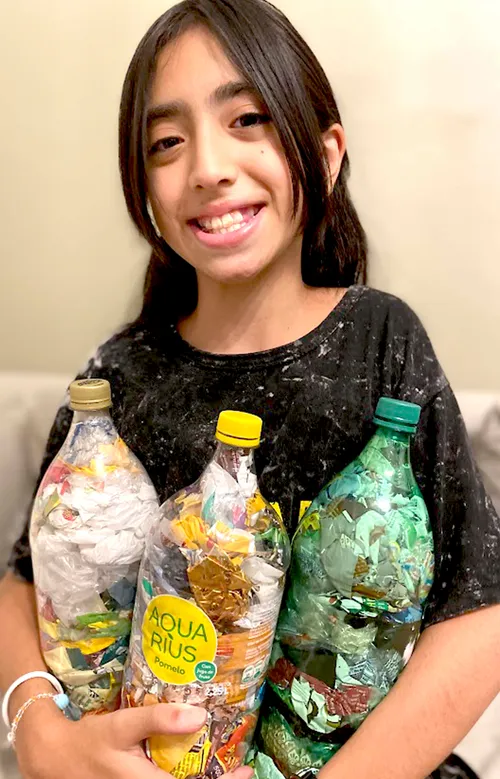 Girl holding plastic bottles