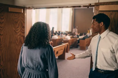 man welcoming woman to chapel