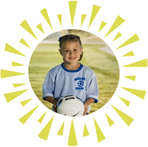 girl holding soccer ball