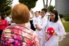 family in white clothes in front of temple