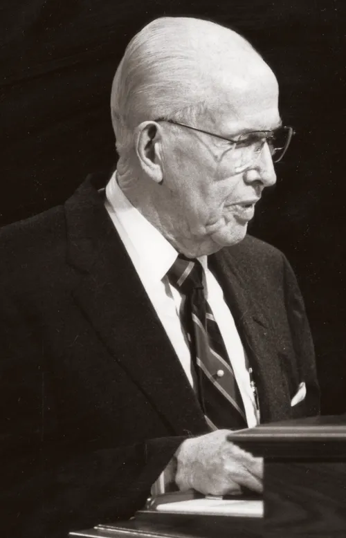 President Ezra Taft Benson speaking at a pulpit.