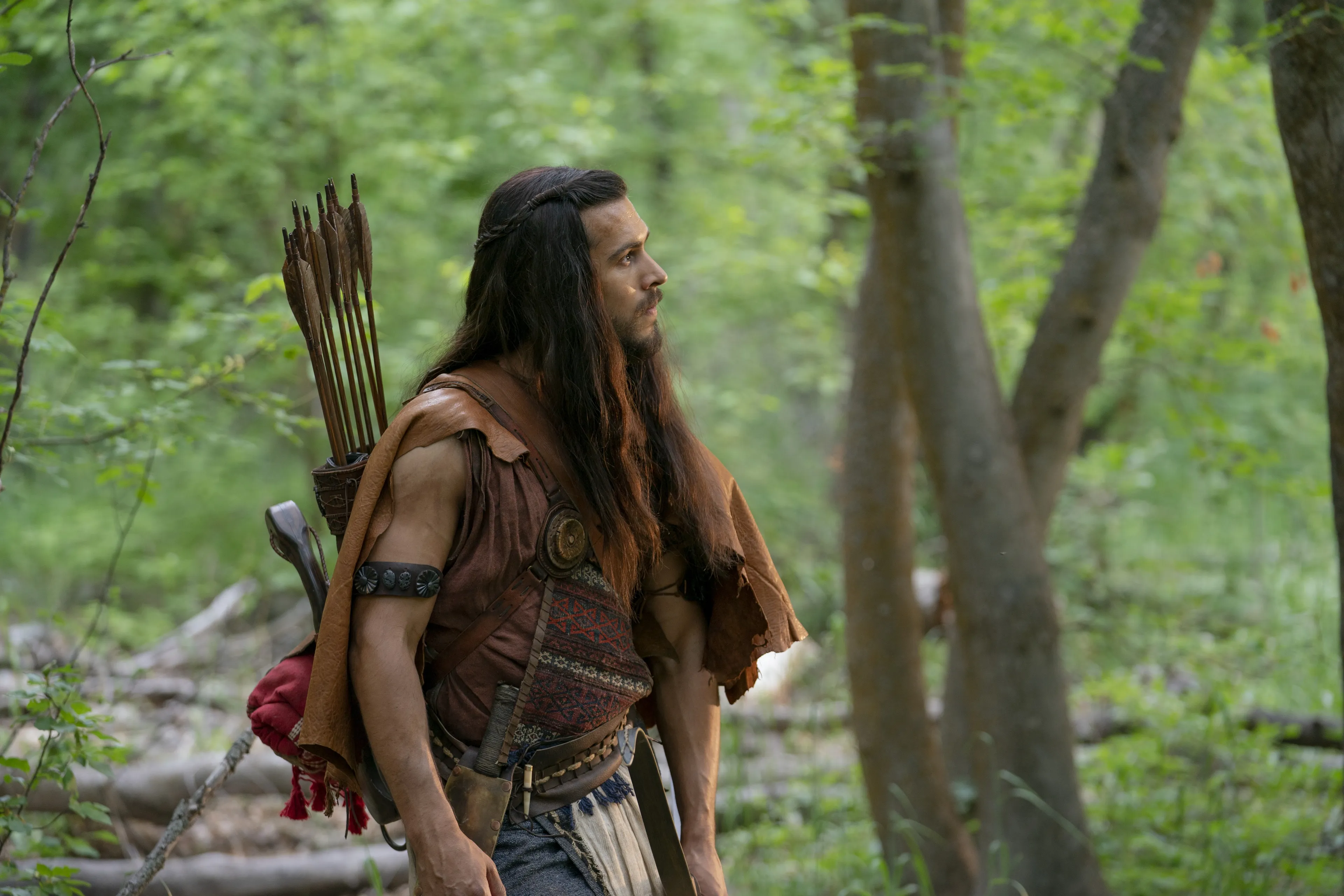 Enos climbs a steep mountainside.