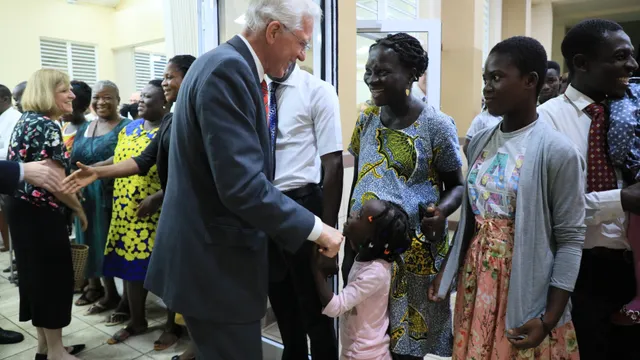 Elder D. Todd Christofferson shaking hands with members at a Member Devotional in Ghana, May 2019.