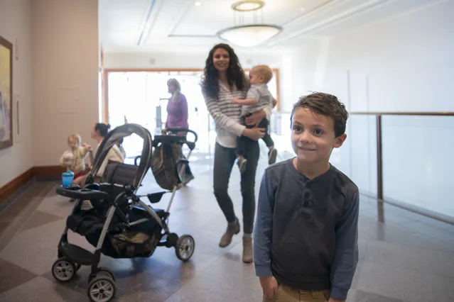 Families walk through the Conference Center exhibits.