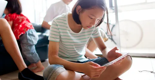 girl looking at tablet