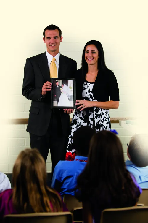 couple holding a picture of their wedding