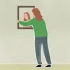 woman hangning up a picture