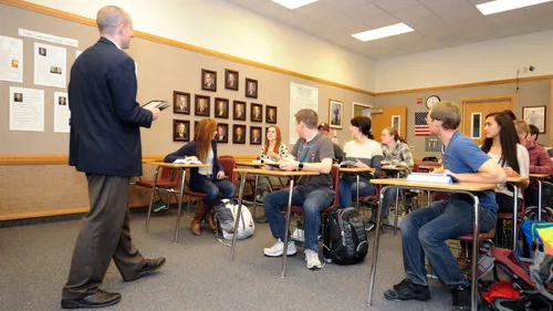 man teaching students