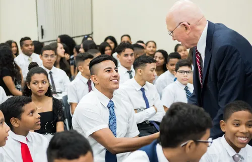 President Dallin H. Oaks shaking hands with a young man