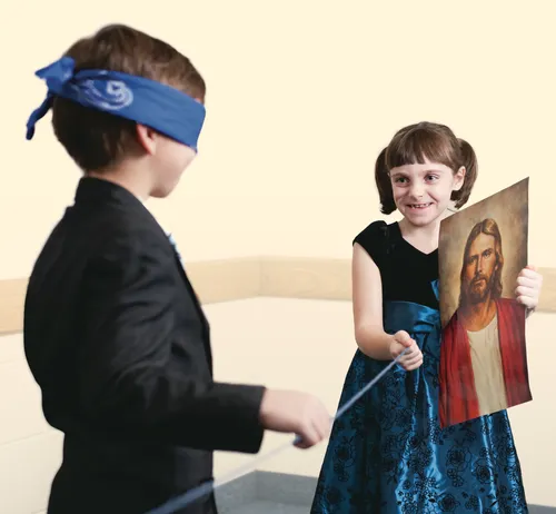 blindfolded boy following a string