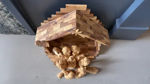 Nativity set with figures all facing Jesus Christ