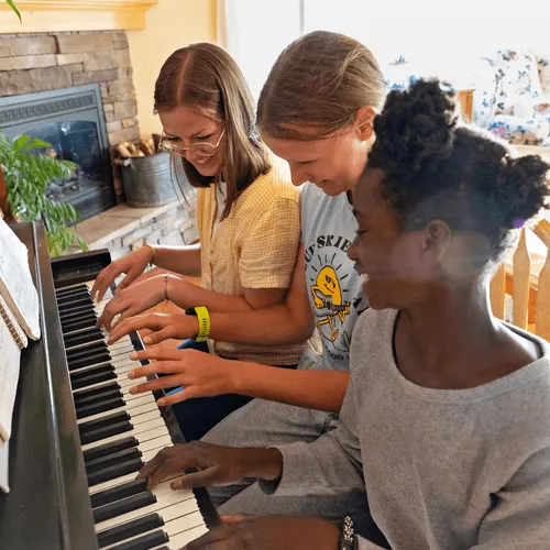 girls playing piano
