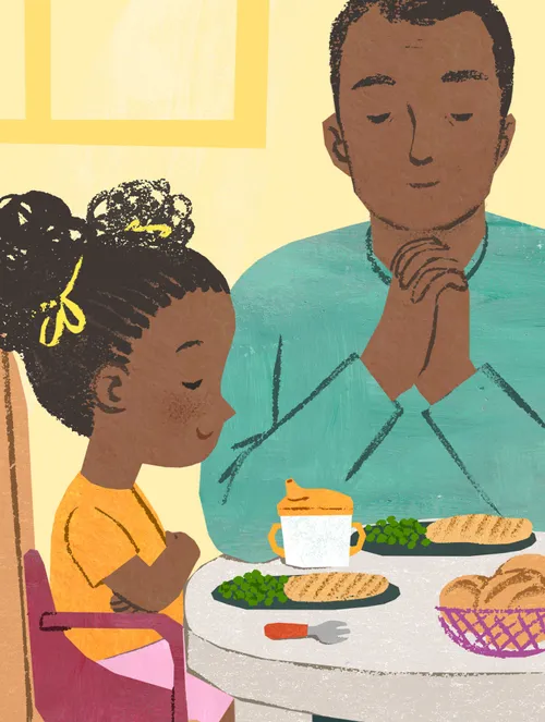 Dad and child praying over a meal