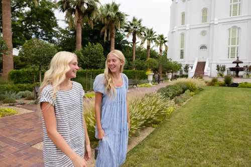 a group of young women walk outside the temple together
