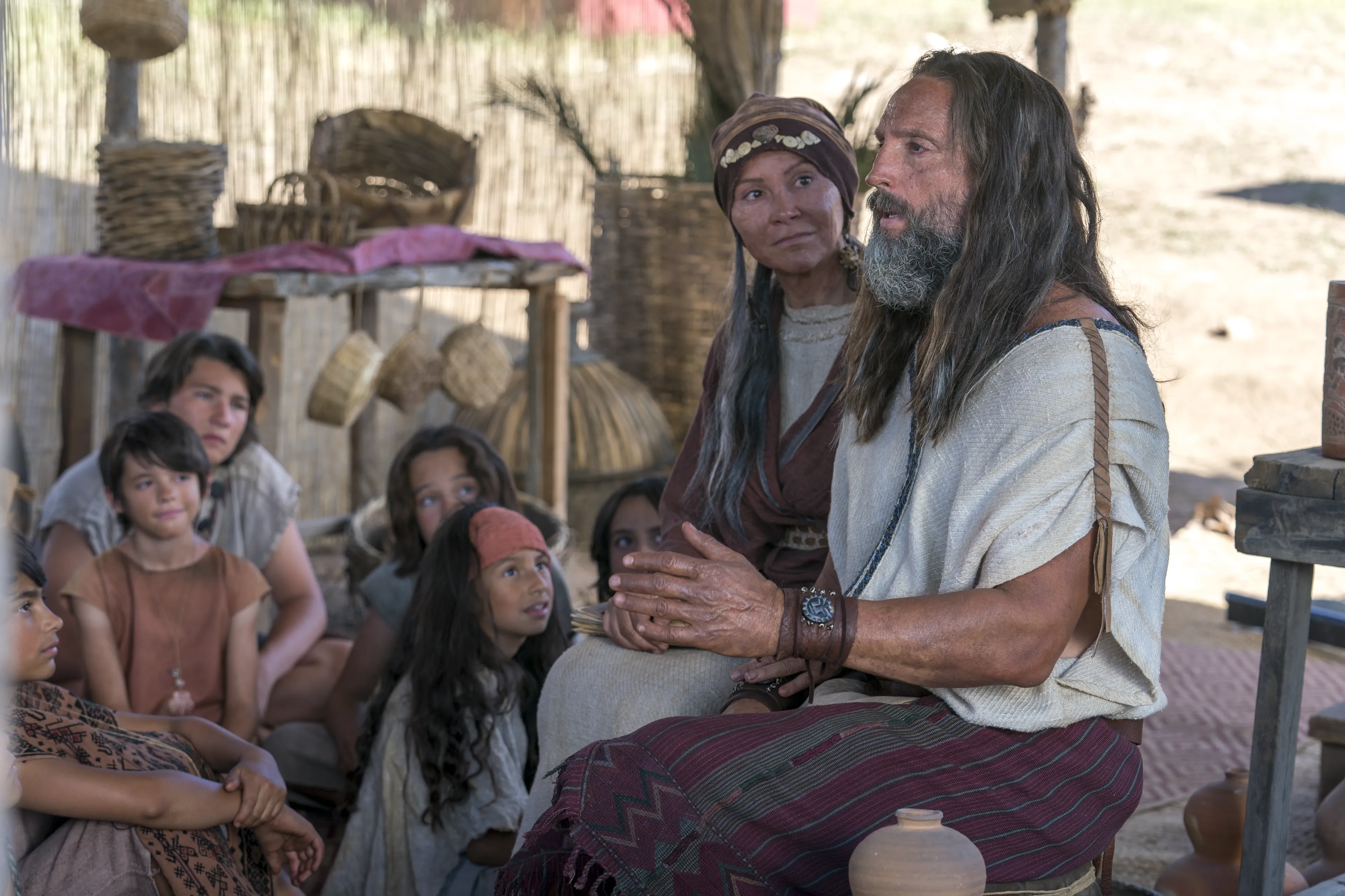 Children listen as Nephi and his wife teach about baptism and the doctrine of Christ.