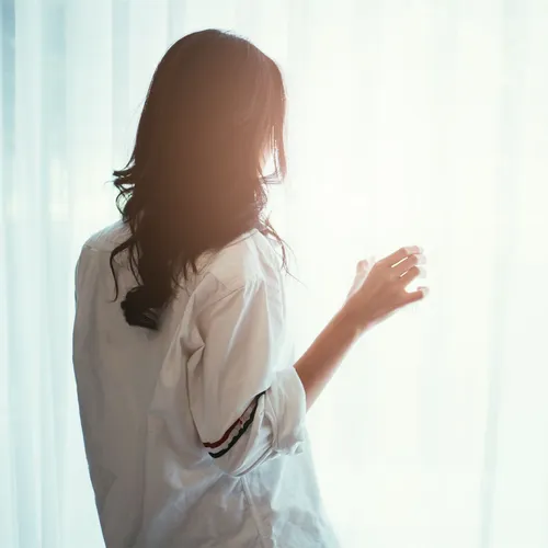 woman looking out a window