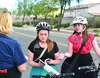 sister missionaries sharing the Book of Mormon with woman