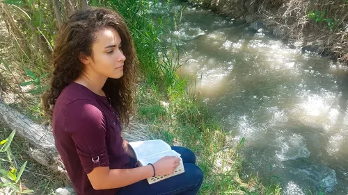 youth reflecting thoughtfully as though seeking revelation