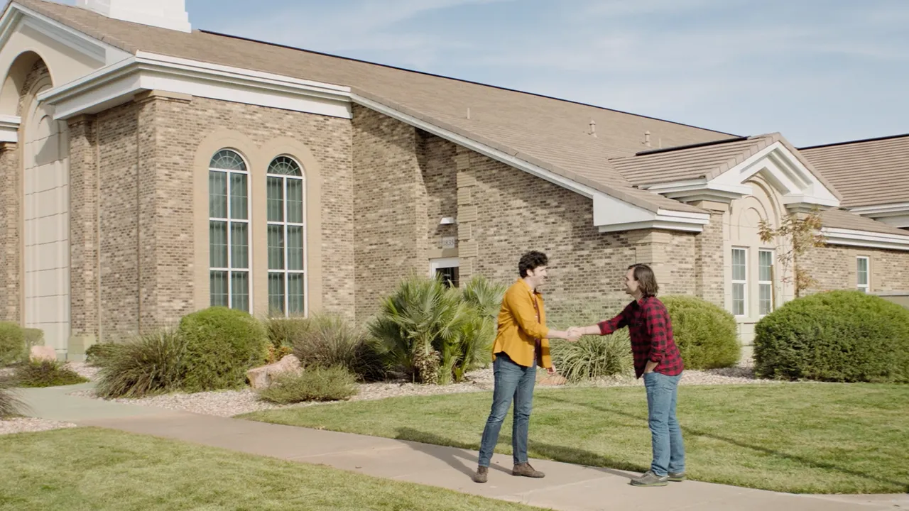 Two men meet outside a church building for a scheduled tour of the building