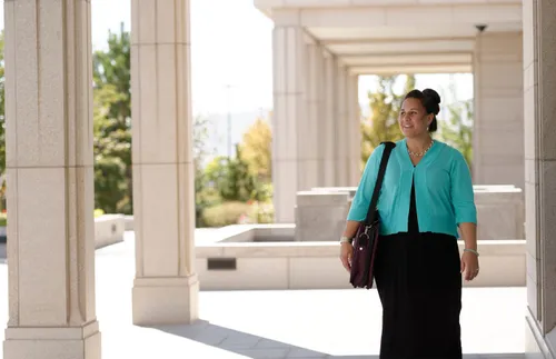 woman walking in front of the temple