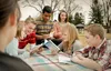group of youth reading the For the Strength of Youth booklet