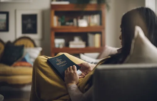 young woman sitting in chair with scriptures