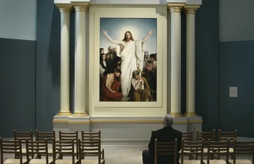 man viewing painting of Christ
