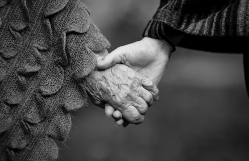 black-and-white image of hands clasped