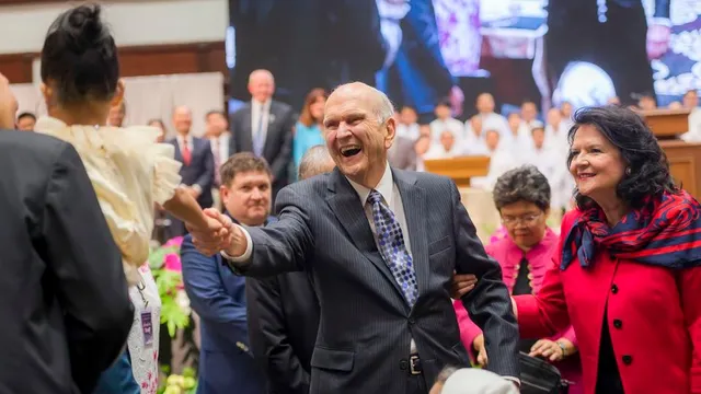 President Russell M. Nelson reaches out to a young girl in Bangkok, Thailand, during his global ministry tour, Friday, April 20, 2018.