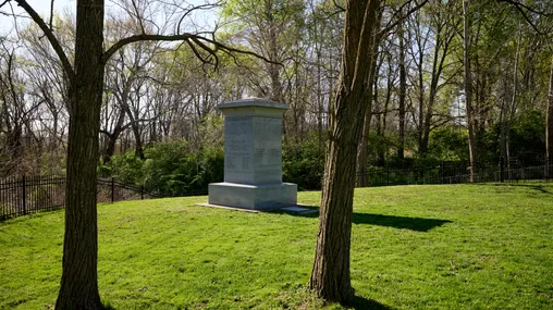 Image of a Monument to the Eight Witnesses of the Book of Mormon in Liberty, Missouri. The monument stands majestically near the graves of  two of the Eight Witnesses