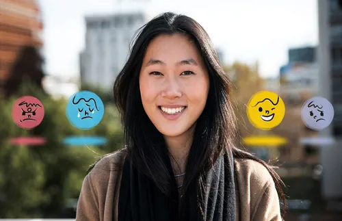 a smiling woman surrounded by different emotion icons