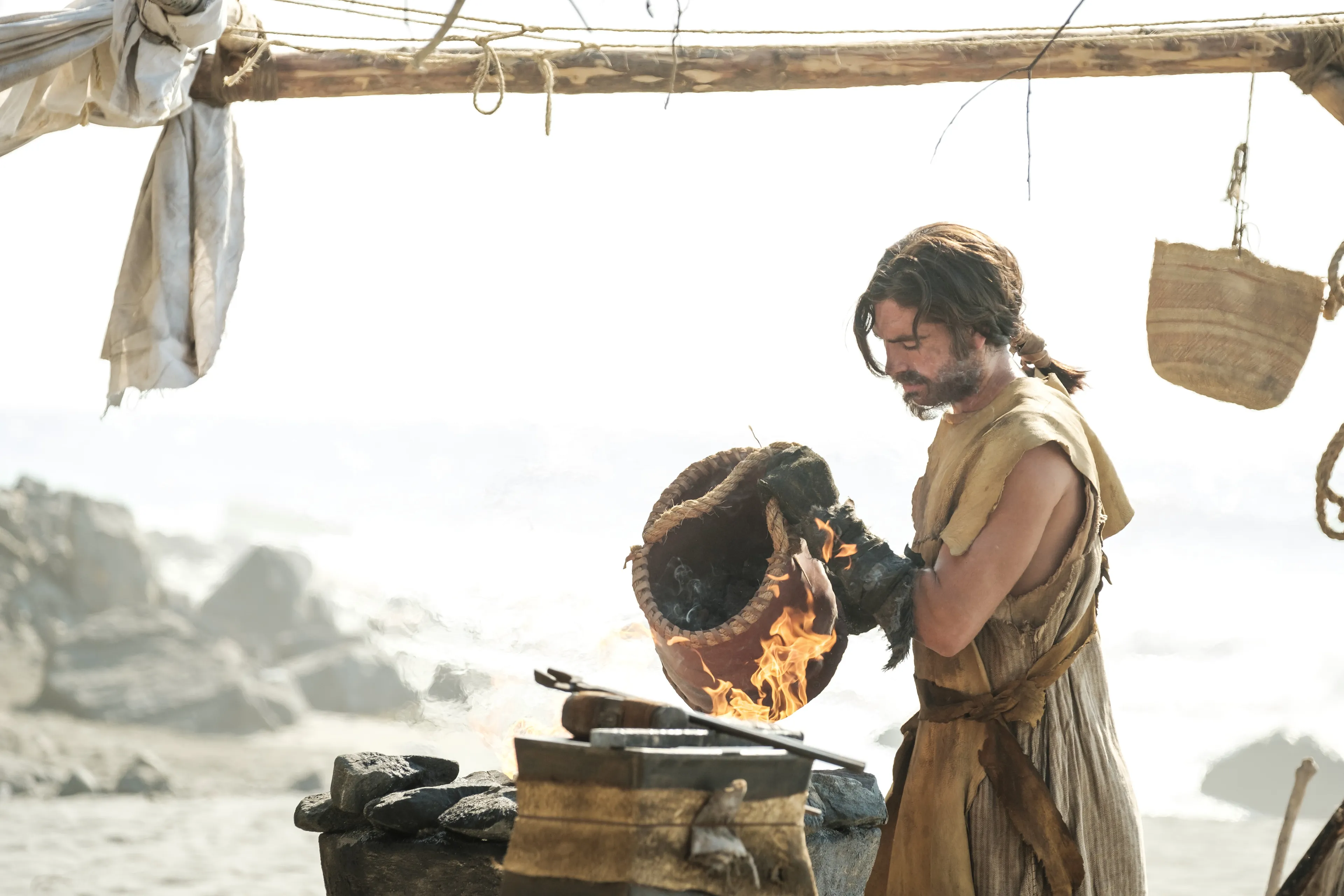 Nephi forges tools to build a boat.