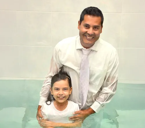 Emily and her dad in the baptismal font