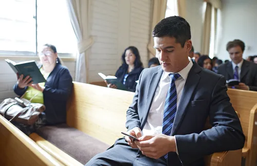 youth on phone during church