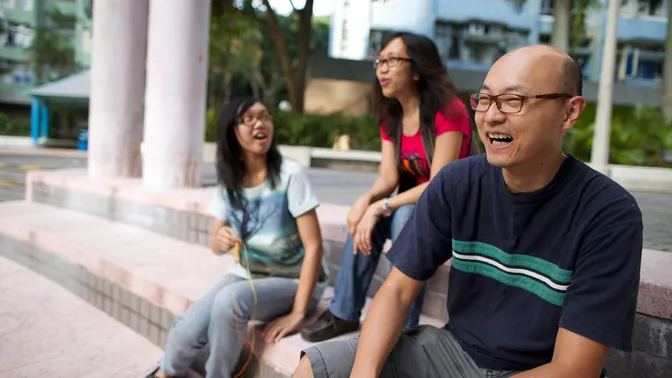 Family life in Hong Kong.  Images include: Family at ocean, laughing together, reading, praying, playing games etc.