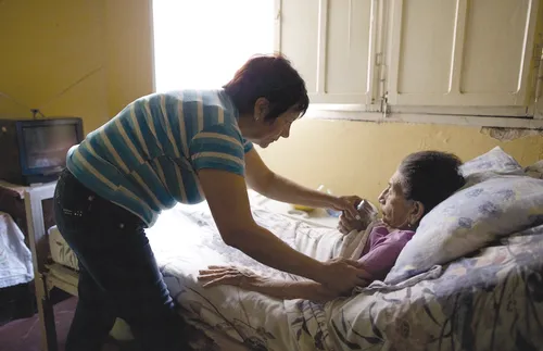 Serving a bed-ridden elderly woman