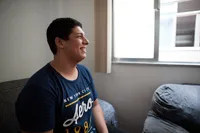 A man sitting in his bedroom