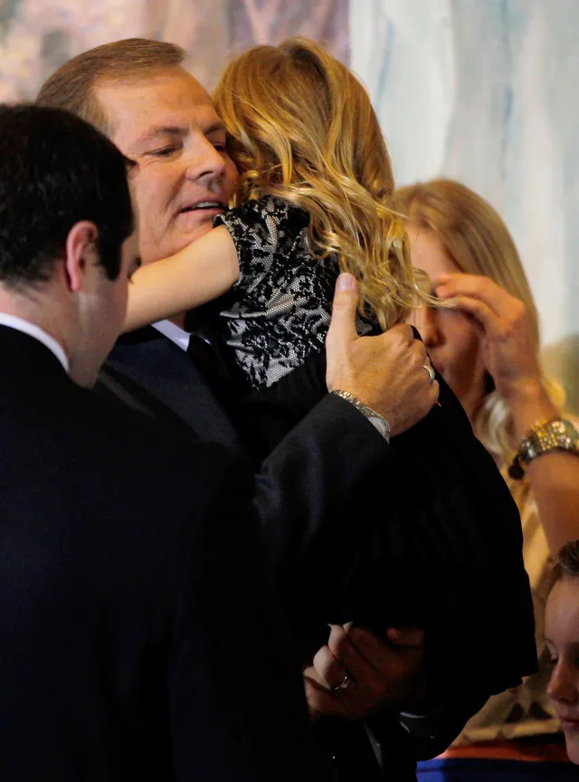 Elder Gary E. Stevenson gives a hug to one of his granddaughters after a press conference.