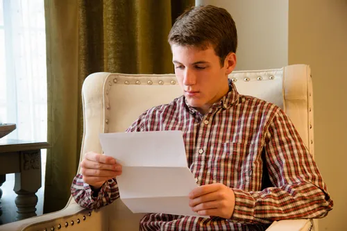 young man reading patriarchal blessing