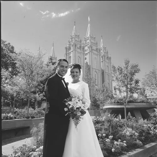 bride and groom in front of temple