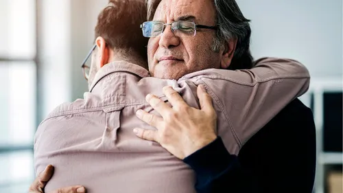 father and son embracing