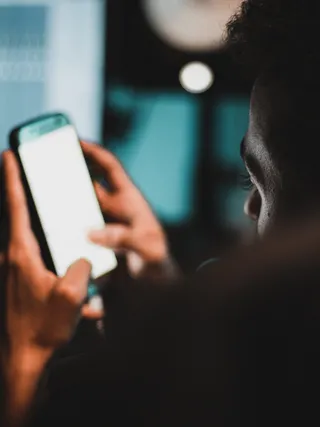 a young adult looking at a cell phone