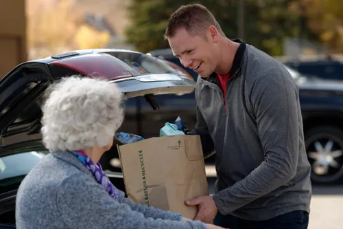 man helping elderly woman
