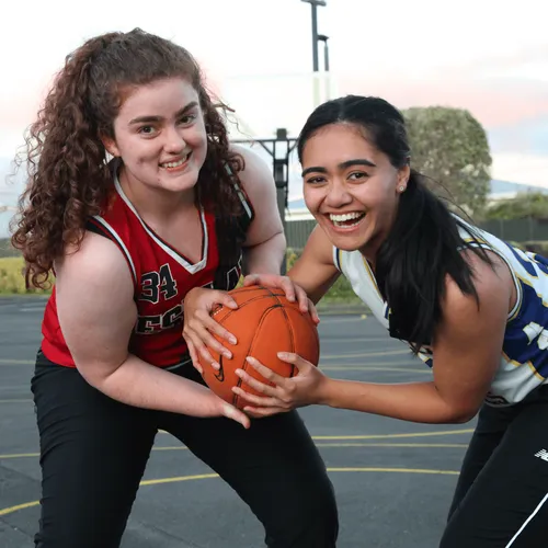 young women playing basketball