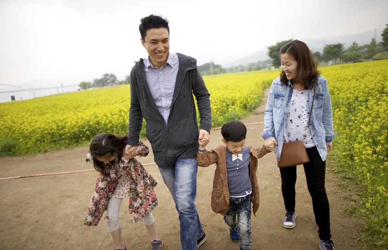 A young family walking and holding hands