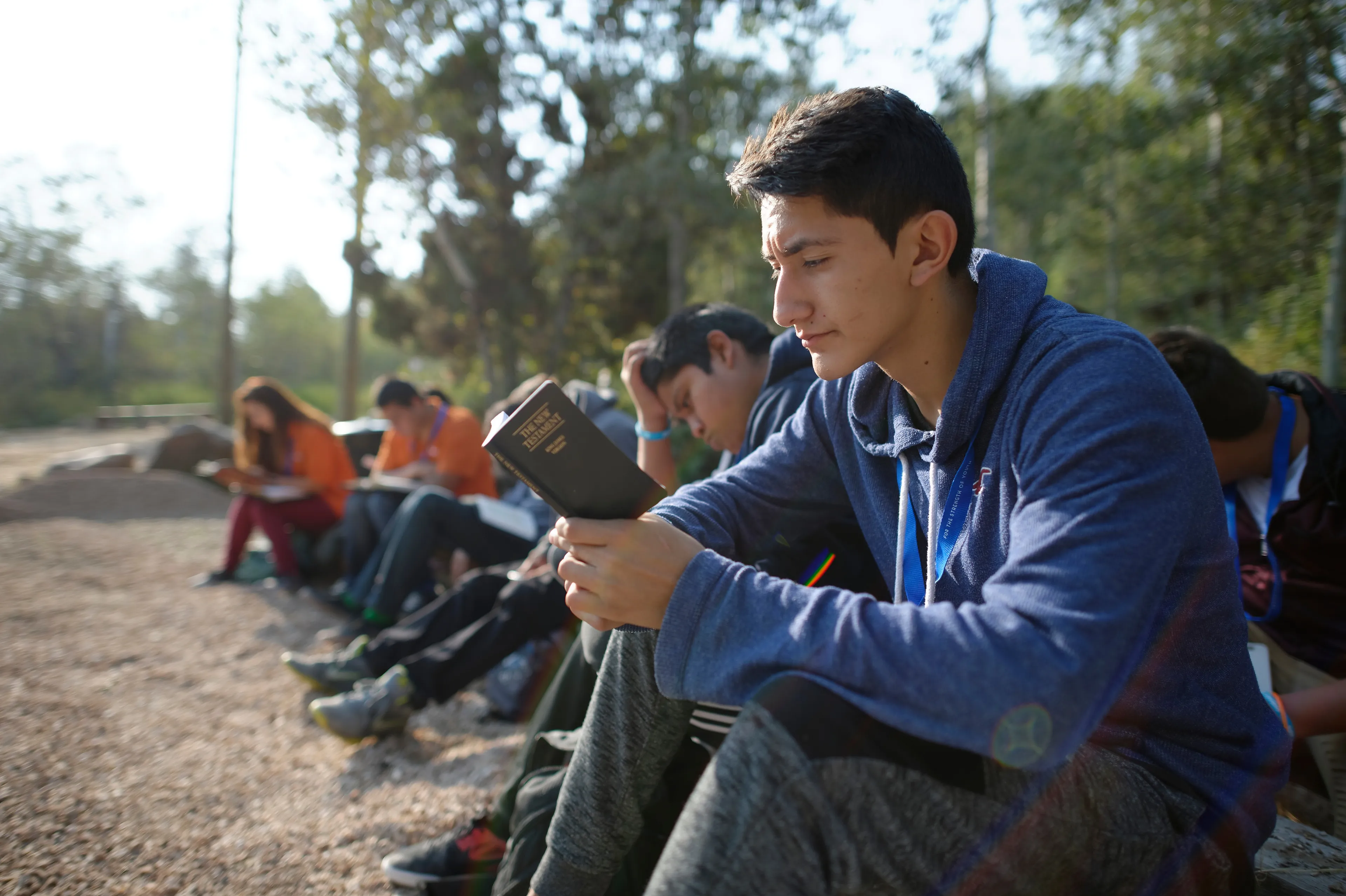 A group of youth reading.